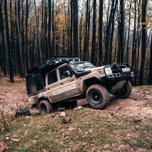 Jeep driving up small hill